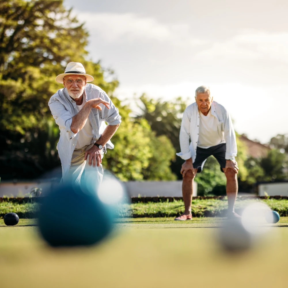 older men playing bocce ball